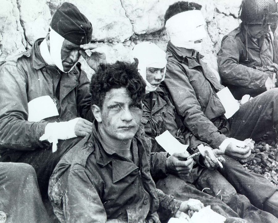 Wounded men below the chalk cliffs